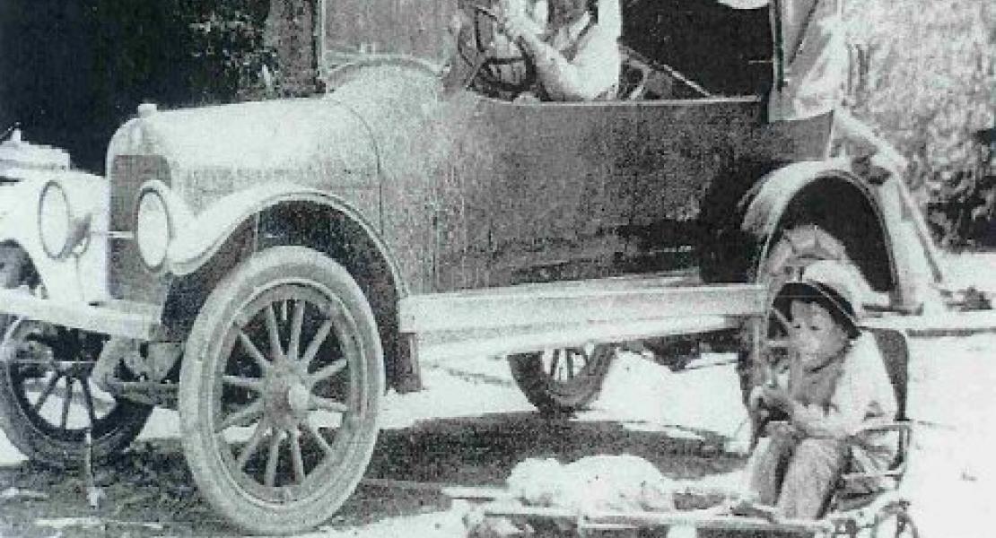 Lorin Walker in his Marmon automobile with crippled son, Franklin, and pig "Daisy"