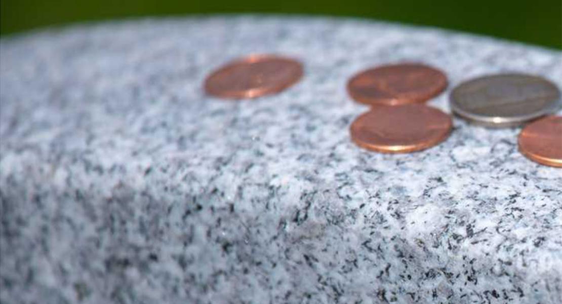 What Do Coins on a Military Gravestone Mean?