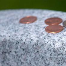 What Do Coins on a Military Gravestone Mean?